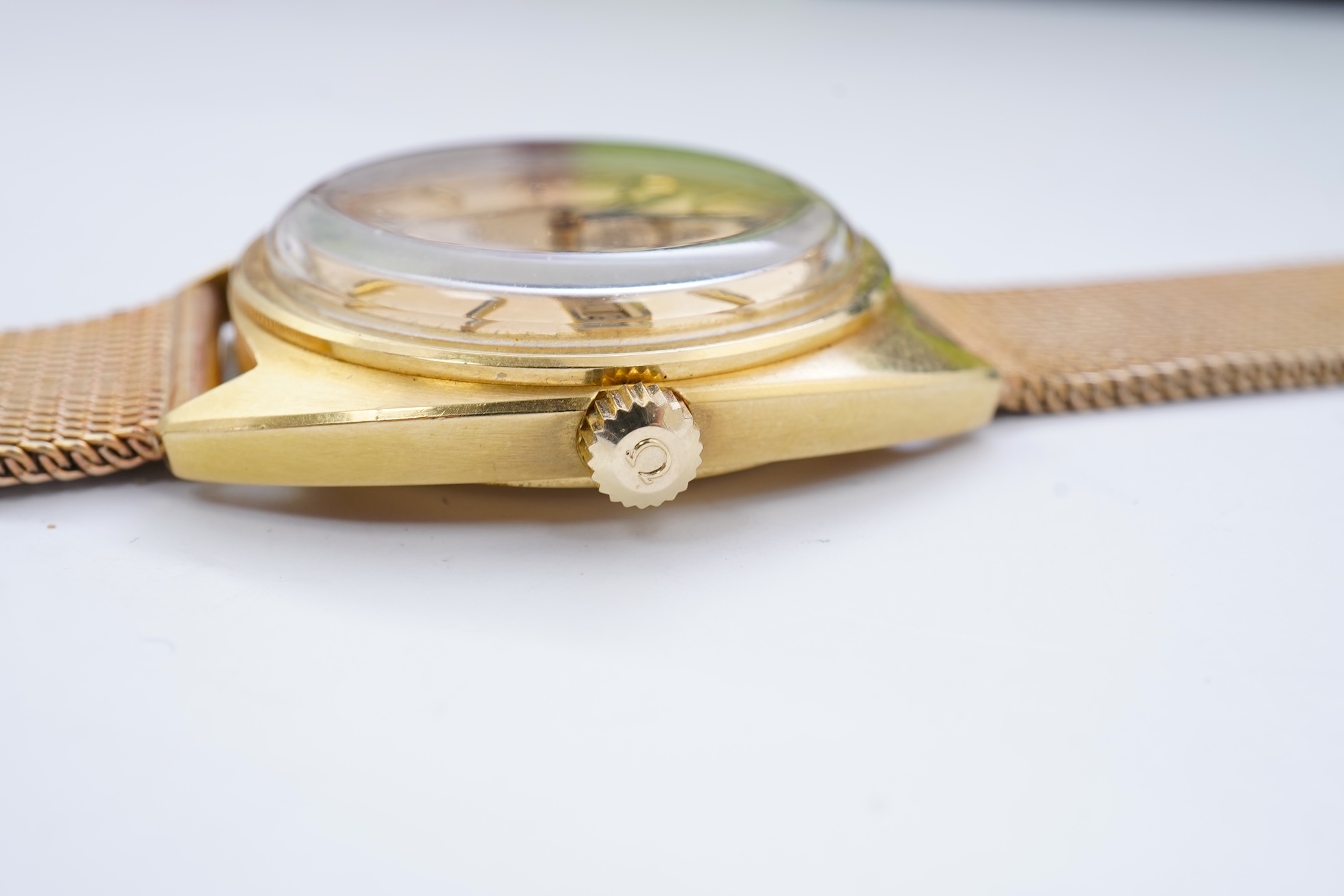 A gentleman's late 1960's 18ct gold Omega Constellation Automatic Chronometer Officially Certified wrist watch, on an associated 9ct gold mesh link bracelet